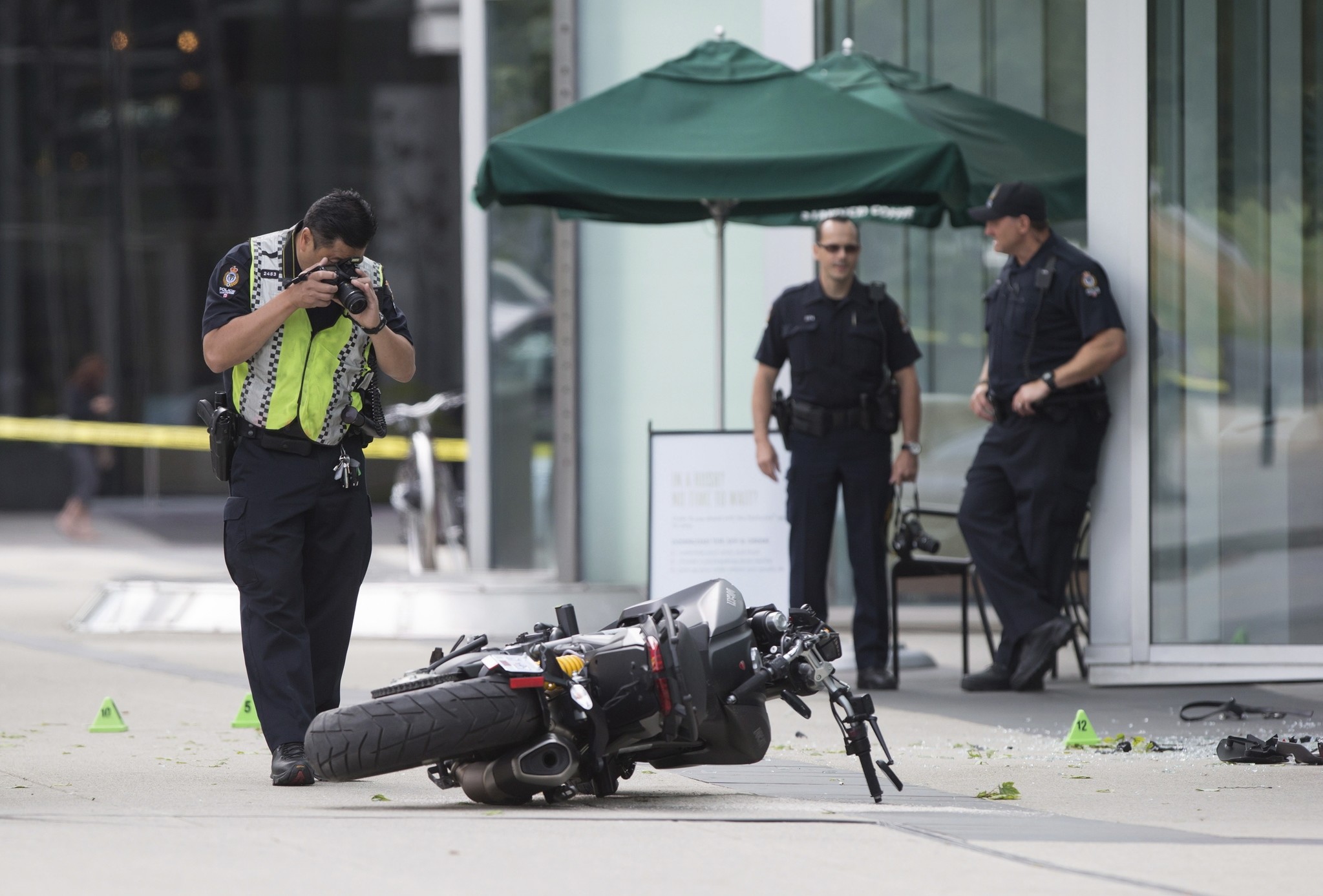 A police officer photographs a motorcycle after a female stunt driver working on the movie ,Deadpool 2, died after a crash on set on Aug. 14, 2017. (AP Photo)