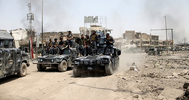 Iraqi Federal Police members ride in military vehicles during the fight with the Daesh militants in the Old City of Mosul, Iraq July 4, 2017. (Reuters Photo)