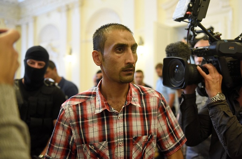 The Afghan leader of a people-smuggling group looks at the media, as he leaves the courtroom, after a guilty verdict in Kecskemet, Hungary, June 14, 2018. (Reuters Photo)