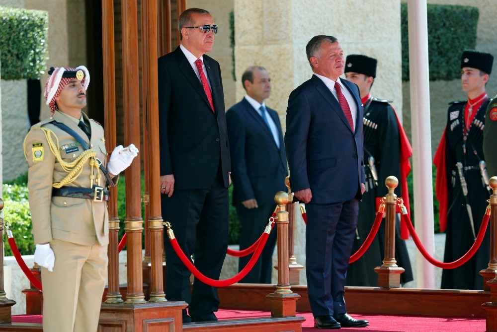 President Erdou011fan (L) and Jordan's King Abdullah II (R) review Bedouin honor guards at the Royal Palace in Amman, Jordan, Aug. 21. 