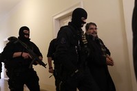 Policemen escort Salih Muslim, former co-chair of the PKK-linked Democratic Union Party, or PYD, to a court room for a custody hearing in Prague, Czech Republic, Tuesday, Feb. 27, 2018. (AP Photo/Petr David Josek)