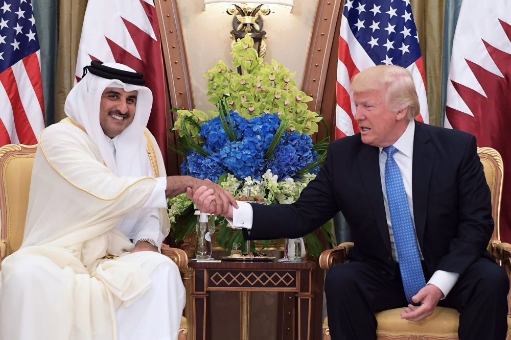This file photo taken on May 21, shows U.S. President Donald Trump shaking hands with Qatar's Emir Sheikh Tamim Bin Hamad Al-Thani, during a bilateral meeting at a hotel in the Saudi capital Riyadh.