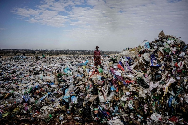 A recycler stands among a tons of plastic rubbish at a sanitary landfill in the industrial city of Bulawayo, Zimbabwe, June 2, 2018. (AFP Photo)  