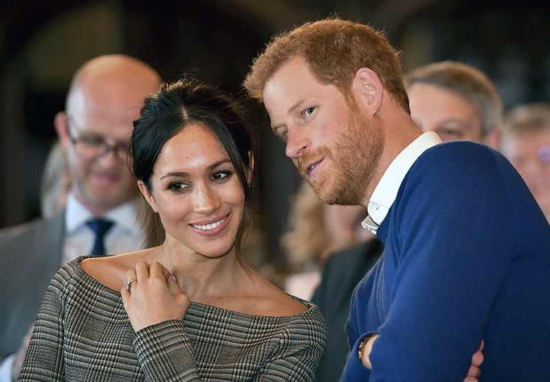 In this Thursday Jan. 18, 2018 file photo, Britain's Prince Harry talks to Meghan Markle as they watch a dance performance by Jukebox Collective in the banqueting hall during a visit to Cardiff Castle, Wales. (AP Photo)