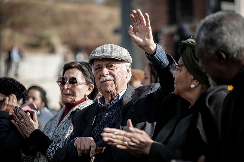 Former Anti-Apartheid activist and South African president Nelson Mandela's lawyer and friend George Bizos waves as he takes part in the global 'Walk Together' initiative event.