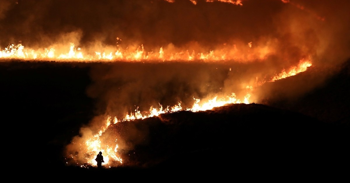 A fire is seen burning on Saddleworth Moor near the town of Diggle, Britain, February 27, 2019. (REUTERS Photo)