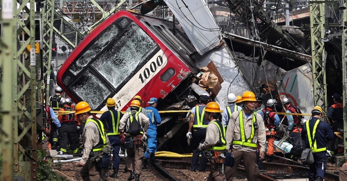 A train sits derailed after a collision with a truck in Yokohama, near Tokyo Thursday, Sept. 5, 2019. (Kyodo News via AP)
