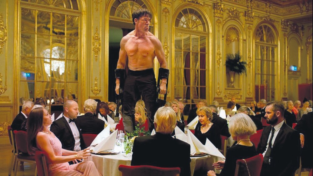 A performance artist acting like an ape, selected to entertain the art-savvy, elegantly dressed public sitting in a very ornate dining hall, tests the boundaries of what the polite audience will endure in order not to break the totem of modern art.