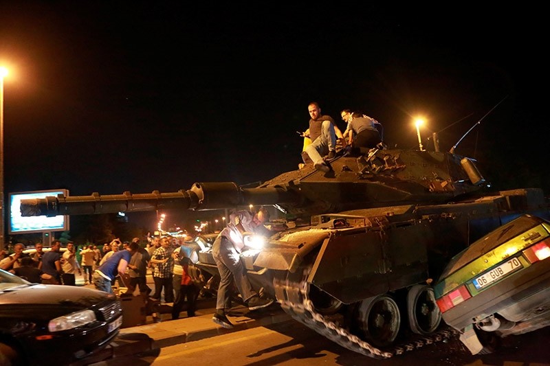 A tank crashes a car as people take streets in Ankara, Turkey during a protest against military coup on July 16, 2016. (AFP Photo)