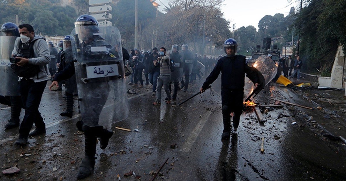 Anti-riot police officers clash with people protesting against President Abdelaziz Bouteflika's plan to extend his 20-year rule by seeking a fifth term in April elections in Algiers, Algeria, March 1, 2019. (Reuters Photo)