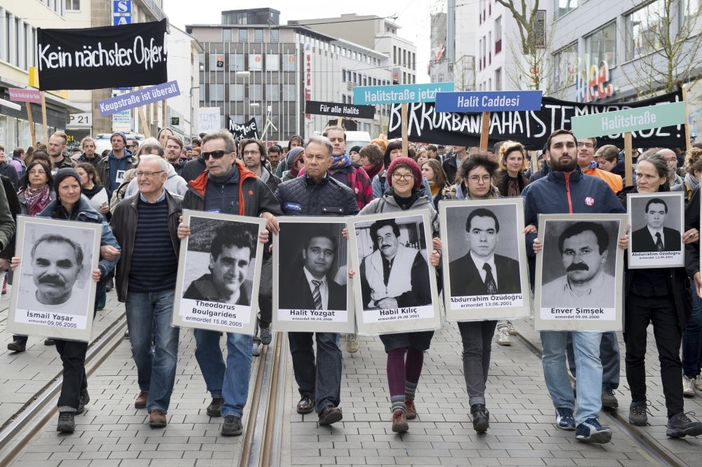 Demonstrators carrying photos of NSU victims and a banner reading ,No Other Victim!, walk through downtown Kassel, Germany on April 6, 2017.