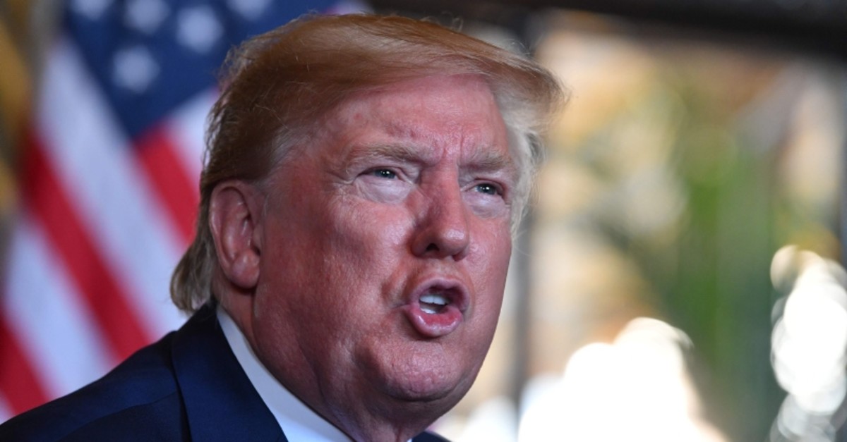 In this file photo taken on December 24, 2019 US President Donald Trump answers questions from reporters after making a video call to the troops stationed worldwide at the Mar-a-Lago estate in Palm Beach Florida. (AFP Photo)