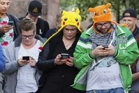 People play u2018Pokemon Go' on their smartphones in Leerdam, the Netherlands. Pokemon Go, a Global Positioning System (GPS) based augmented reality mobile game, launched first on July in the U.S.