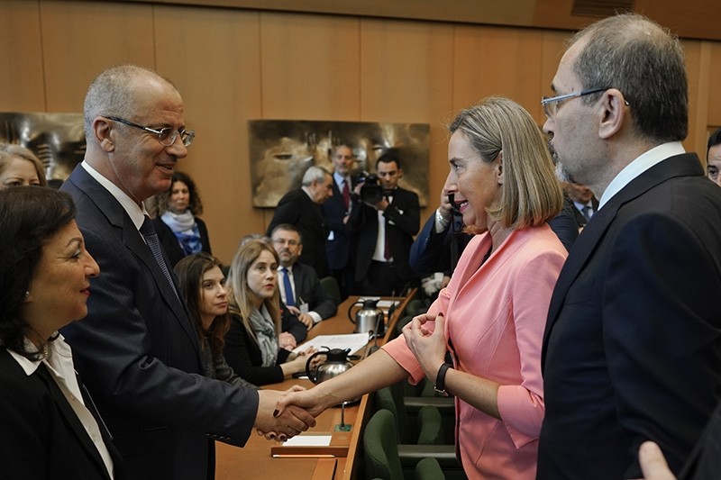 Palestineu2019s Prime Minister Rami Hamdallah, left, shakes hands with EU foreign policy chief Federica Mogherini, center, during a U.N. Relief and Works Agency for Palestine Refugees in the Near East conference, in Rome, March 15, 2018. (AP Photo)