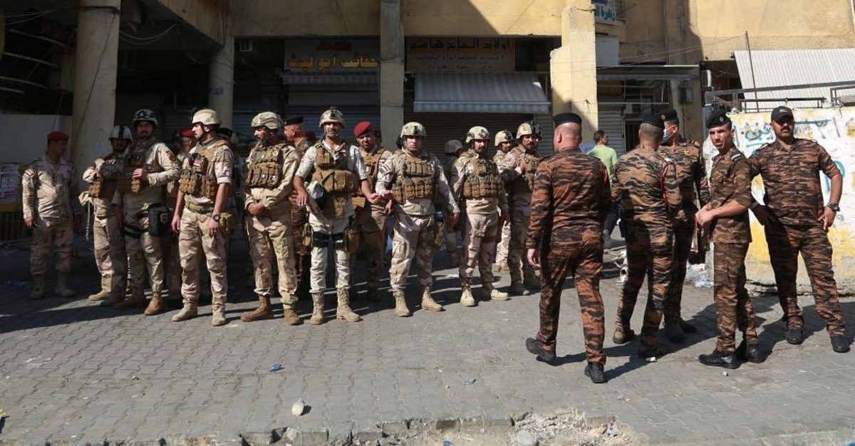Security forces gather near Iraq's central bank in Baghdad, Iraq, Wednesday, Nov. 6, 2019. Iraqi security forces deployed in large numbers around the bank and began evacuating employees from the building. The protesters did not appear to be heading toward the bank itself. (AP Photo/Khalid Mohammed)