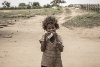 A girl eats a food supplement distributed during a malnutrition screening session organised by a nongovernmental organization and the World Food Programme (WFP) in the municipality of Ifotaka.