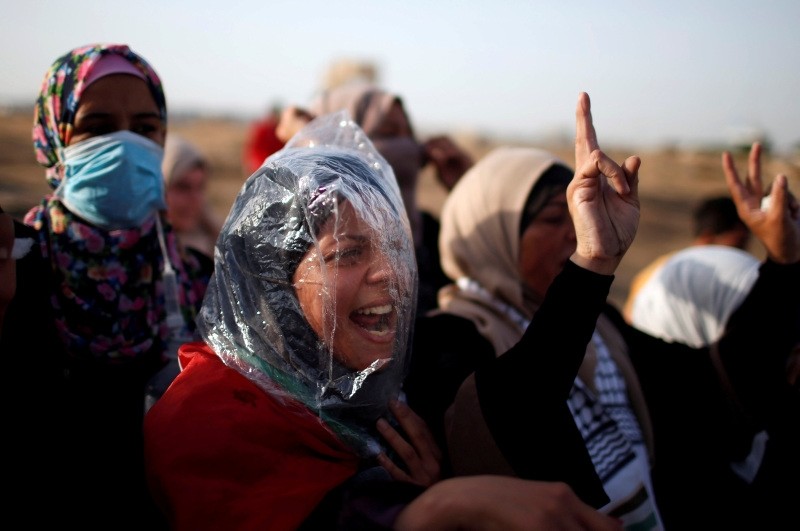 A female demonstrator wearing a plastic bag chants slogans during a protest where Palestinians demand the right to return to their homeland, at the Gaza Strip, east of Gaza City, May 18.