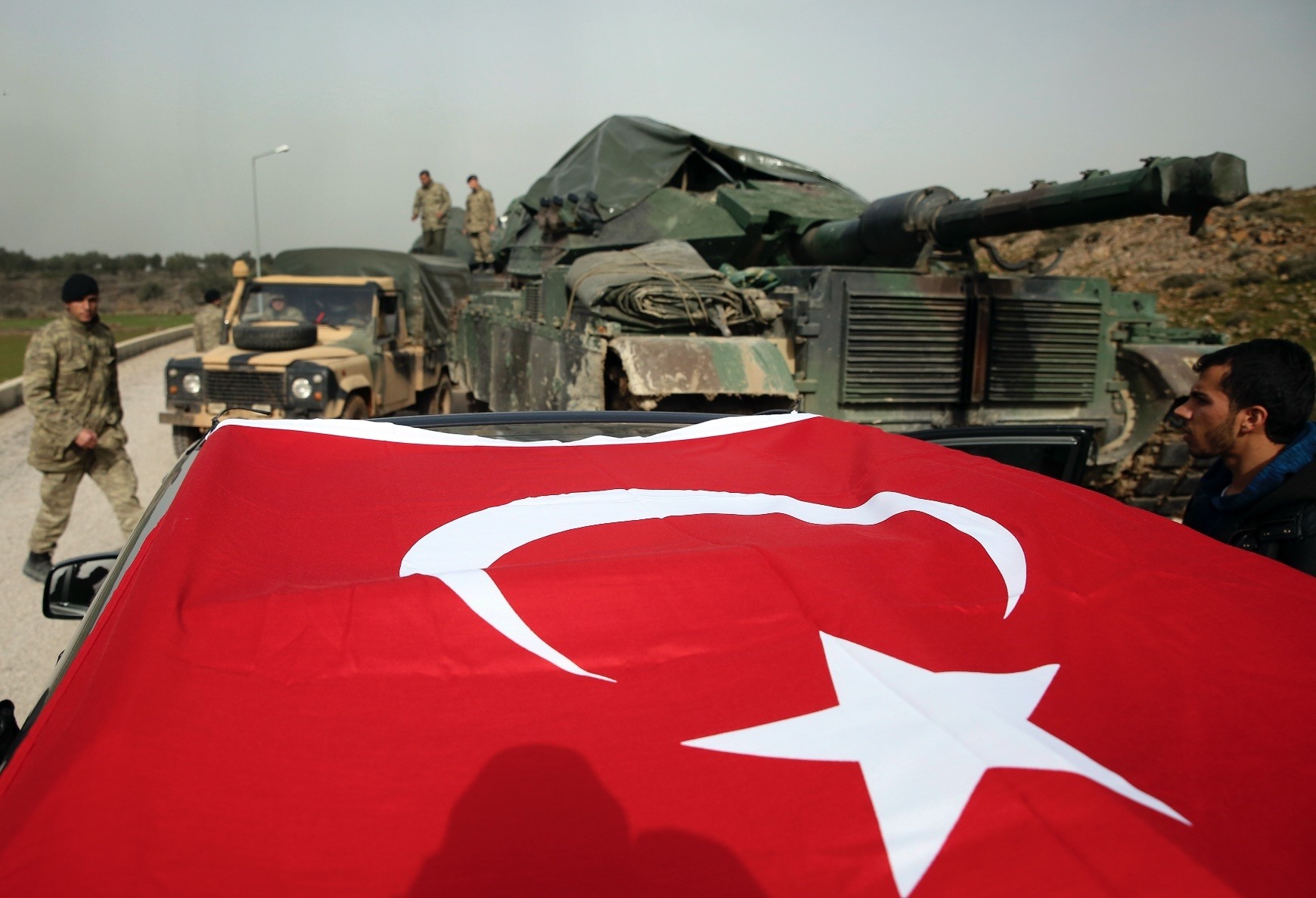 Turkish  soldiers prepare tanks and armored personnel carriers at a staging on the Turkish-Syria border, Jan. 22. 