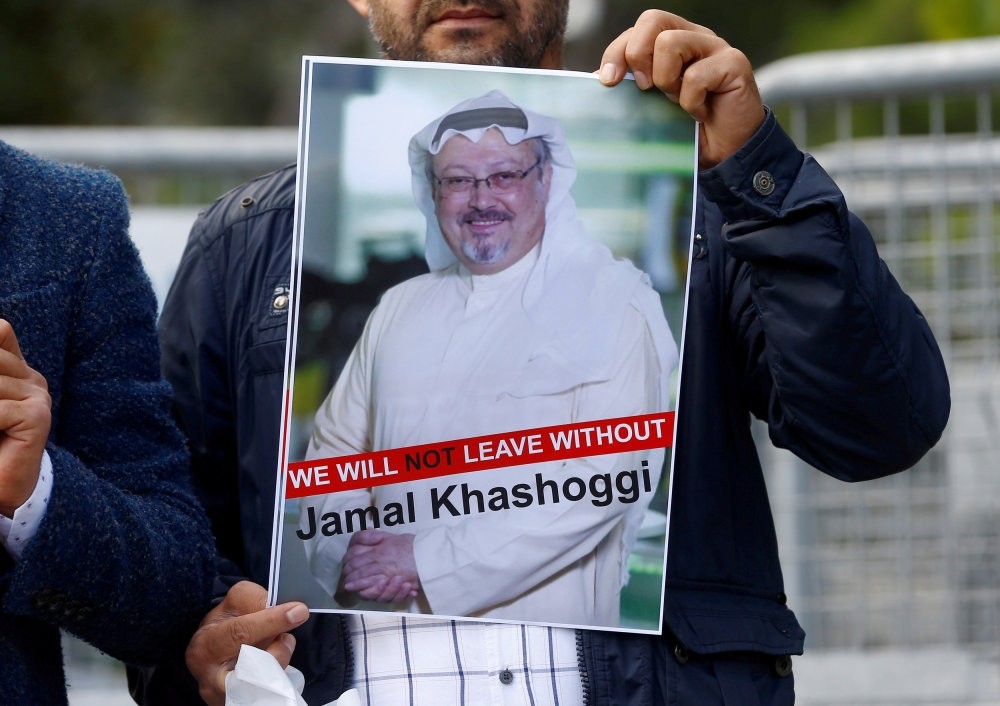 A demonstrator holds a picture of Saudi journalist Jamal Khashoggi during a protest in front of Saudi Arabia's Consulate in Istanbul, Oct. 5, 2018.