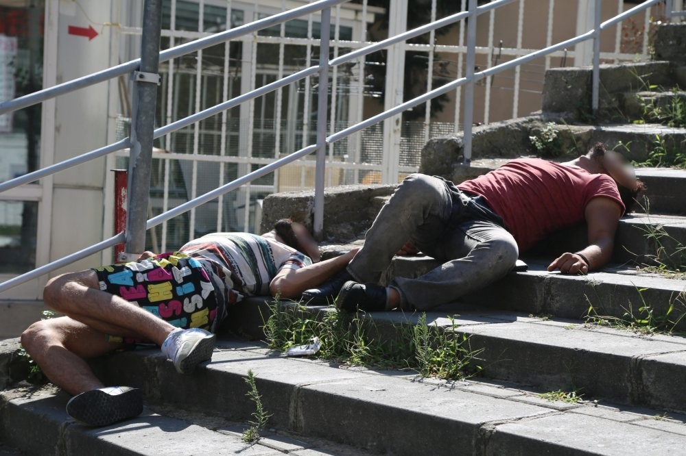 Two young men lie unconscious on the stairs in Istanbul's u015eiu015fli district after using bonzai. Bonzai is a cheap and popular drug, especially among the youth.