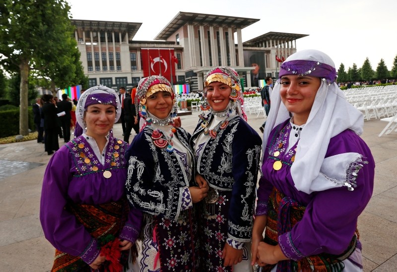 Guests dressed in traditional costumes pose for photos outside the Presidential Complex in Ankara, Turkey, in preparation for a ceremony for President Erdoğan, on Monday, July 9, 2018.