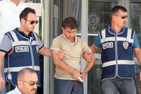 Police officers escort Kayapu0131nar after his arrest.