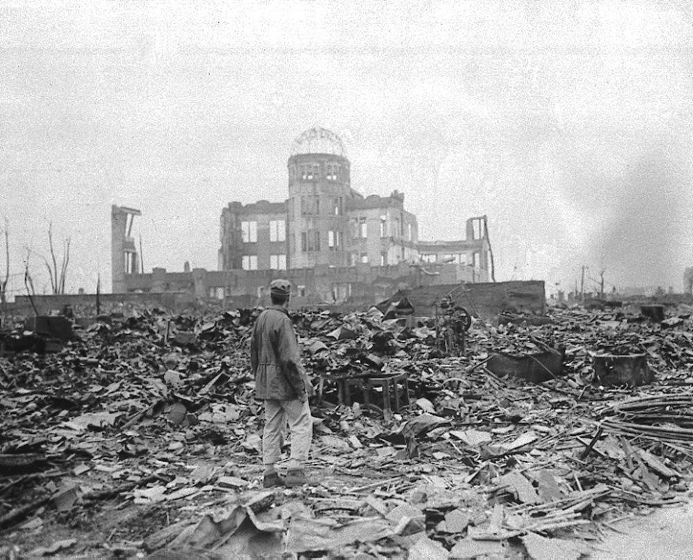 An allied correspondent stands in a sea of rubble before the shell of a building that once was a movie theater in Hiroshima, Aug. 6, 1945 - three days before the another deadly attack in Nagasaki, Japan.