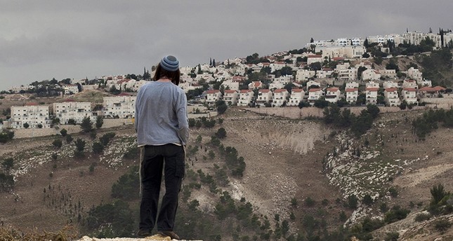 In this Dec. 5, 2012 file photo, a Jewish settler looks at the West bank settlement of Maaleh Adumim, from the E-1 area on the eastern outskirts of Jerusalem. (AP Photo)