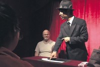 A magician taking stage at Magic Lamp.