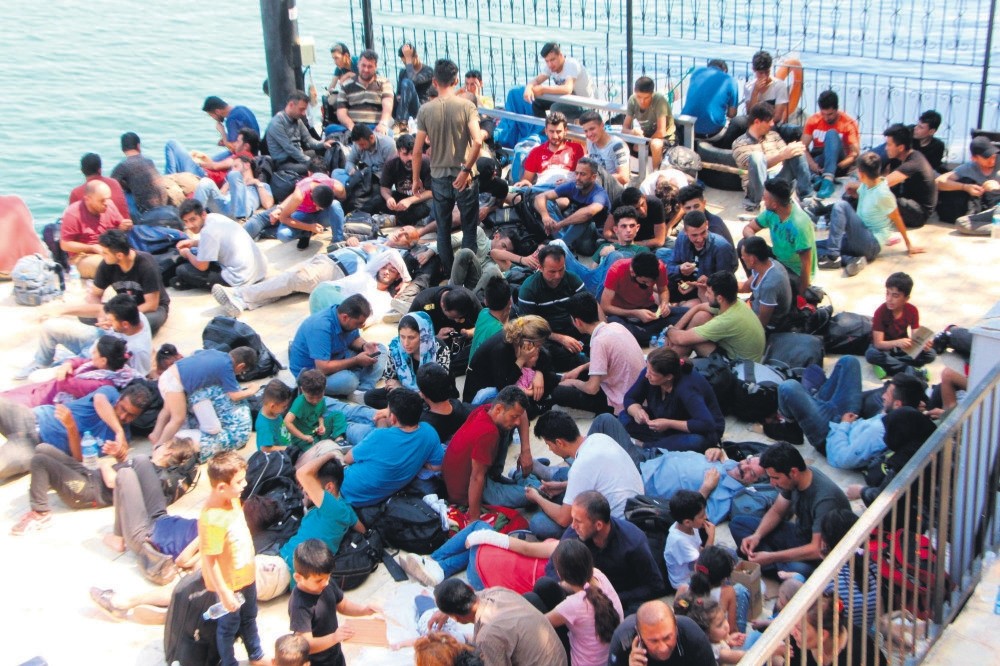 Syrian migrants rest on the port after they were rescued from a sinking boat by the Turkish Coast Guard in the Seydikemer district of Muu011fla, Turkey, July 2017.