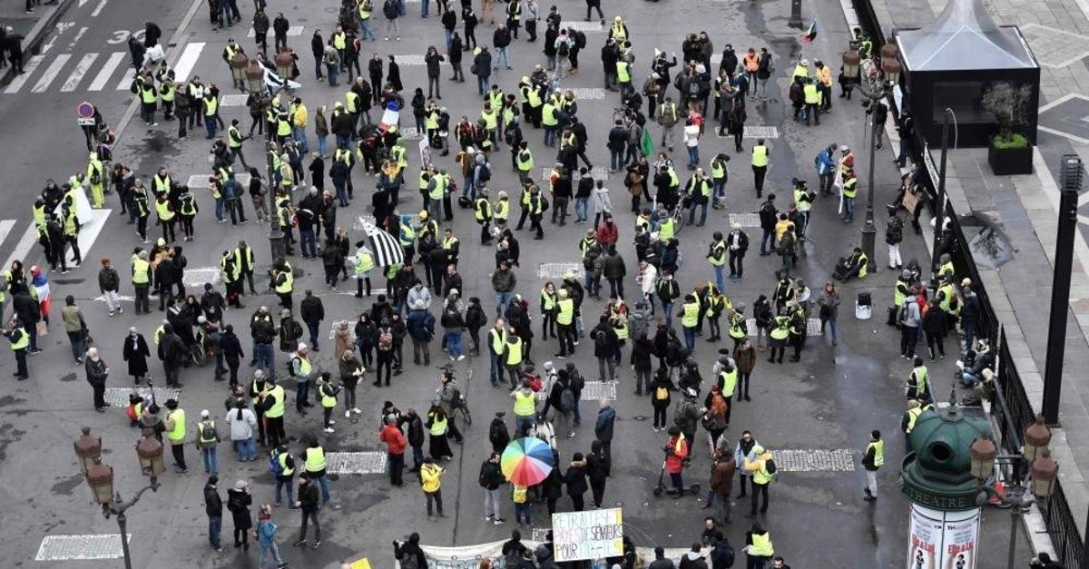 Protesters gather on the Place de la Bourse in Paris during a demonstration by the Yellow Vest movement on December 28, 2019, as part of a nationwide multi-sector strike against French government's pensions overhaul. (Photo by STEPHANE DE SAKUTIN / AFP)