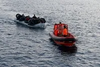 A Turkish Coast Guard boat tows a boat carrying migrants off the coast of u00c7eu015fme, a district of u0130zmir, in this undated photo.