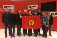 Several German parliamentarians pose with the PKK flag in the German Bundestag, in a photo from November, 2014. 