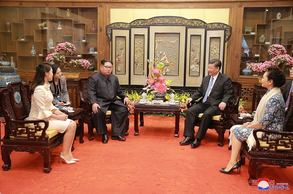 In this March 27, 2018, photo, North Korean leader Kim Jong Un, center left, and his wife Ri Sol Ju, left, talk with Chinese counterpart Xi Jinping, second from right, and his wife Peng Liyuan at Diaoyutai State Guesthouse in Beijing.