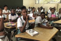 Students at Andres Bello primary school show books and stationary handed out by Tu0130KA, March 31, 2019.