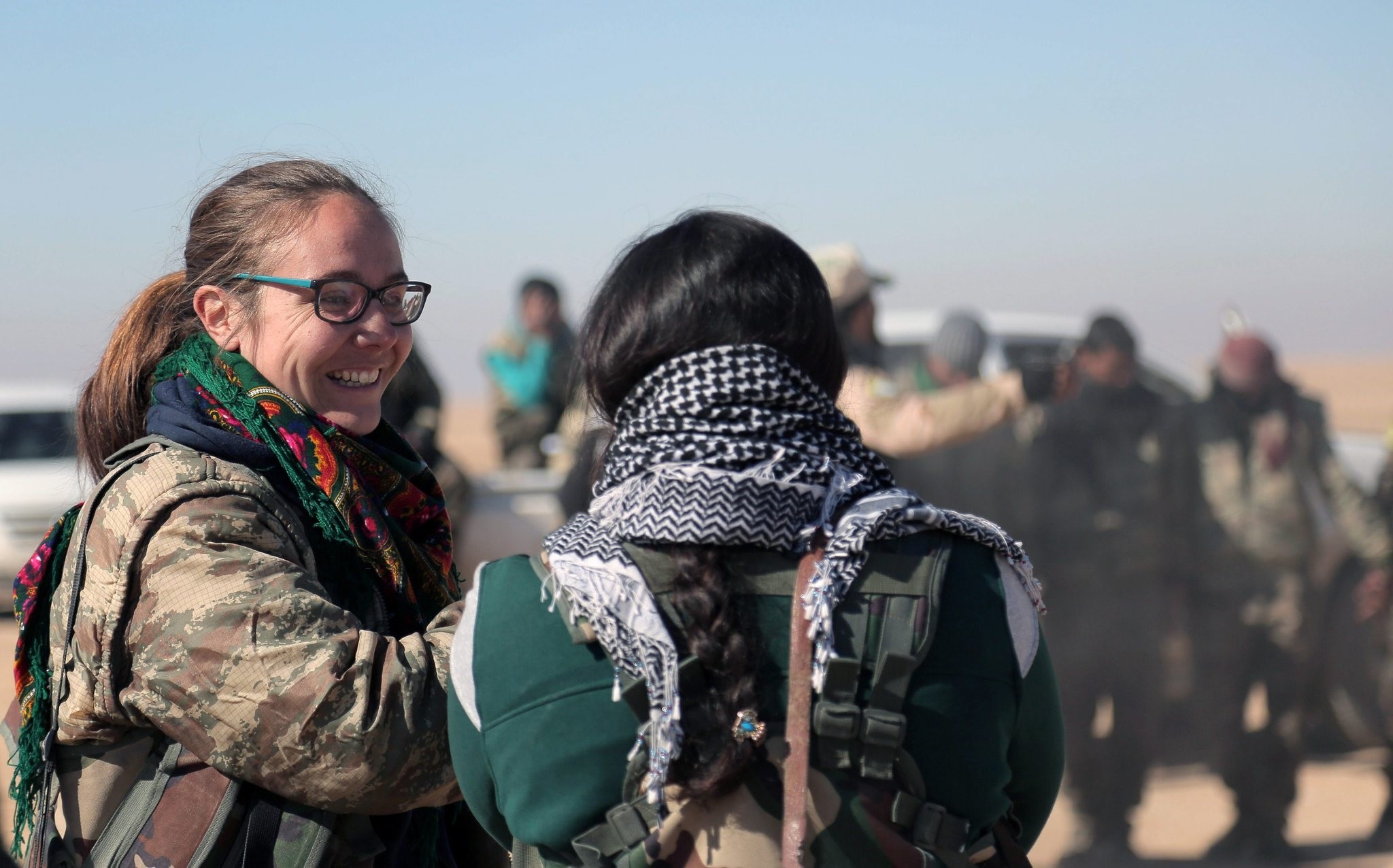 A volunteer British fighter talks with a member of the Syrian Democratic Forces (SDF), north of Raqqa, Syria, Feb. 3, 2017.