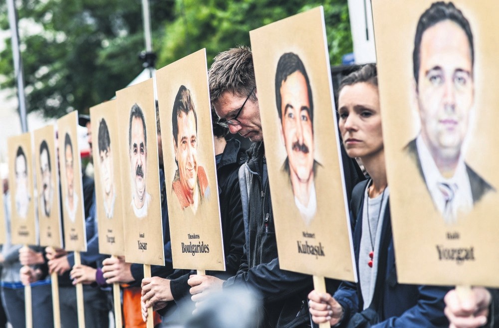 People hold portraits of NSU victims in front of the Higher Regional Court in Munich, Bavaria, Germany, July 10 .