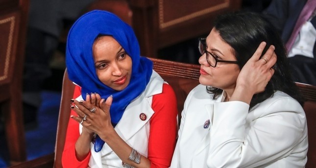 In this Feb. 5, 2019 file photo, Rep. Ilhan Omar, D-Minn., left, joined at right by Rep. Rashida Tlaib, D-Mich., listen to President Donald Trump's State of the Union speech, at the Capitol in Washington (AP Photo)