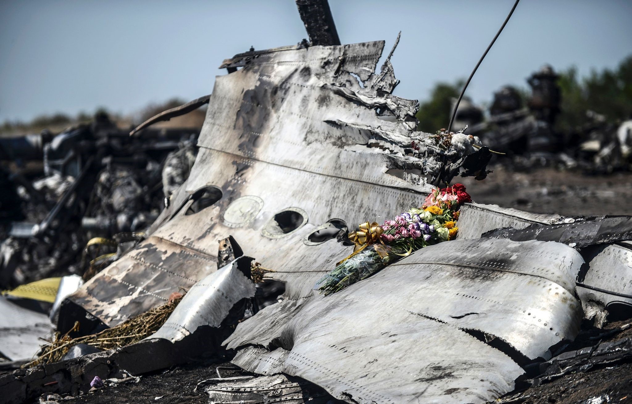 File photo taken on July 26, 2014 shows flowers laid on a piece of the Malaysia Airlines plane MH17, near the village of Hrabove (Grabove), in the Donetsk region. (AFP Photo)