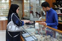 A Saudi jeweler attends to a client in a shop in the Tiba gold market, Riyadh.