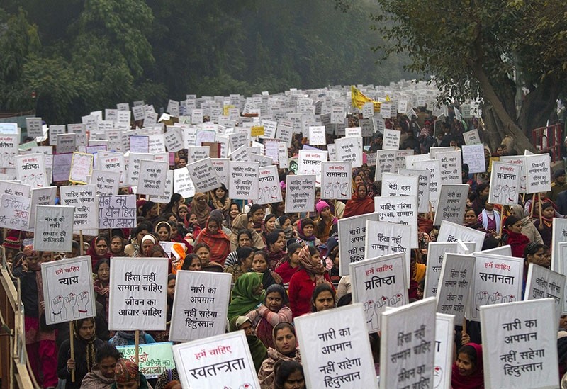 In this file photo, Indian women carry placards as they march to mourn the death of a gang rape victim in New Delhi, India, Wednesday, Jan. 2, 2013.  (AP Photo)