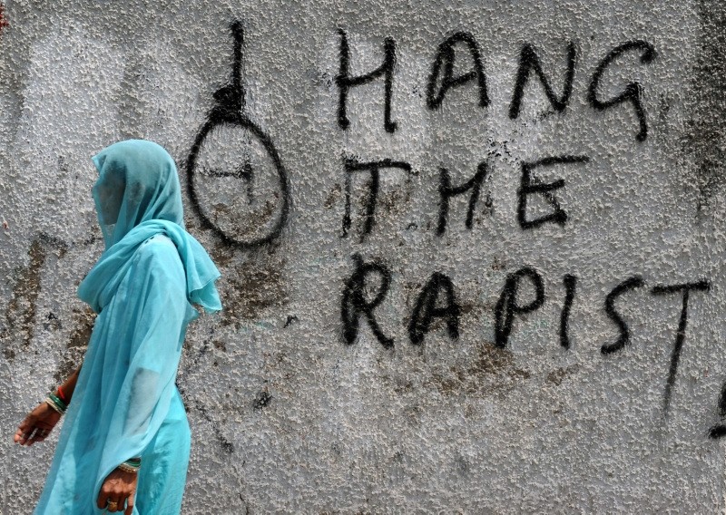 A woman walks past graffiti against rape written on a wall in New Delhi, India, April 22, 2013. (AFP Photo)