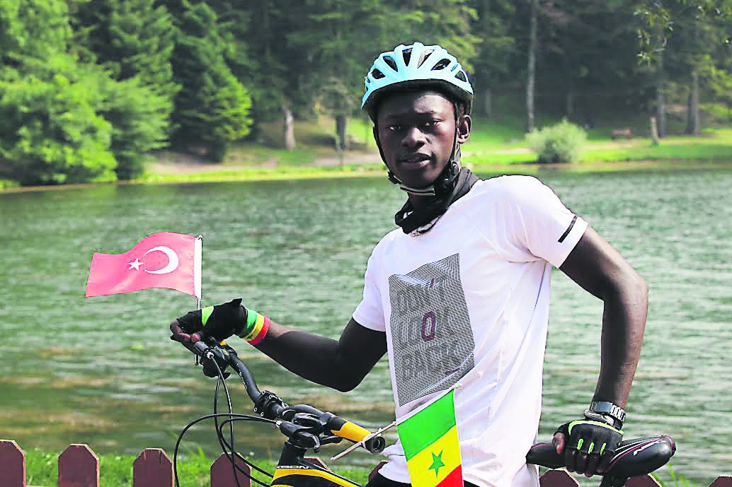 Senegalese Mustafa Ndiaye poses on his bike.