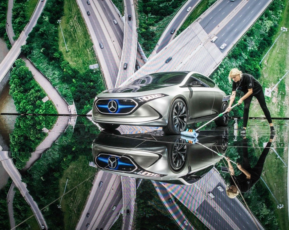 An employee cleans around electric concept car EQ A in Mercedes booth at the Internationale Automobil Ausstellung (IAA) auto show in Frankfurt am Main.