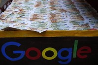 A trunk full of fake bank notes is displayed as activists from anti-globalization organization Attac stage a protest at Google's Paris headquarters to criticize the company's tax evasion policies, in Paris, Jan. 31, 2019. (AP Photo)