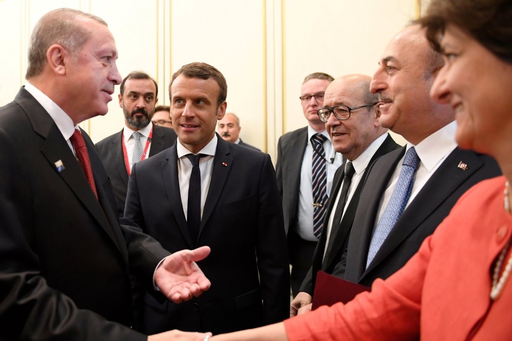 President Erdou011fan (L) shakes hands with French Def. Min. Goulard (R) as he & FM u00c7avuu015fou011flu (2nd R) meet with their French counterparts, Pres. Macron (2nd L) & Minister for Europe & Foreign Affairs,  Le Drian, (3rd R) ahead of NATO summit in Brussels. 