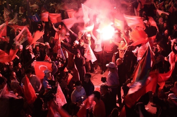 Turkish people waving their national flags as they celebrate the victory of the 'yes' campaign in Sunday's referendum, Istanbul, April 16. 