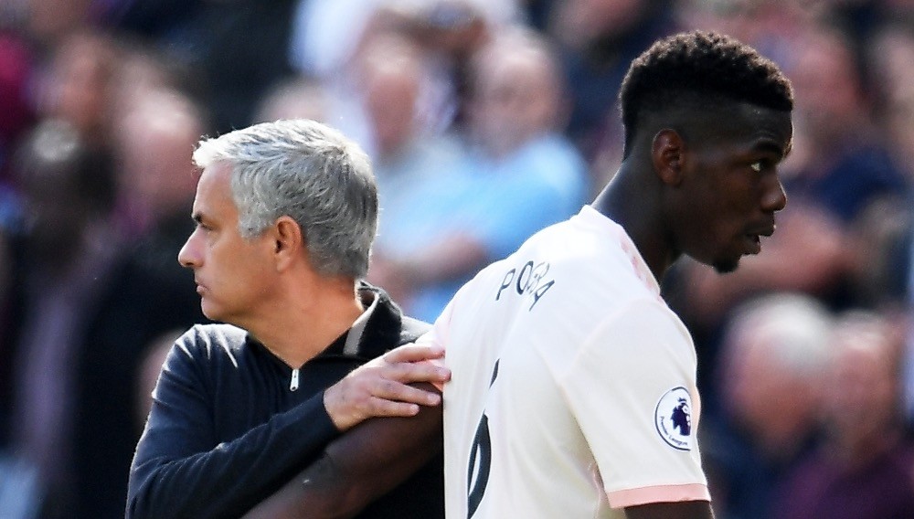 Jose Mourinho (L) and Paul Pogba react during the  English Premier League match between West Ham United and Manchester United in Stratford, east London, Sept. 29.