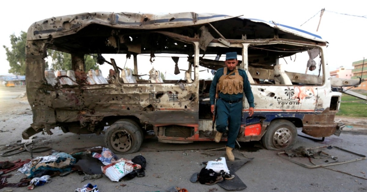 An Afghan policeman inspects a damaged minibus after a blast in Jalalabad, Afghanistan Oct. 7, 2019. (Reuters Photo)