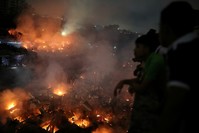 People gather at a rooftop to watch the fire that broke out at a slum in Dhaka, Bangladesh, August 16, 2019. (Reuters Photo)